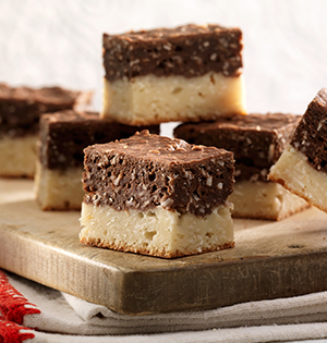 Vanilla Chocolate Coconut Bars made with Astro Yogurt on a wooden serving board.
