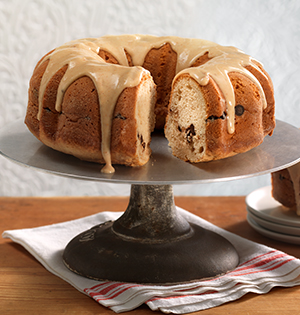 Peanut Butter Chocolate Cake made with Astro Yogurt sitting on a vintage cake stand