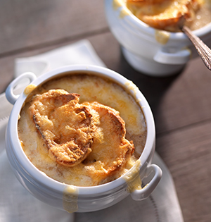 Decadent Mushroom Soup Au Gratin made with Astro Yogurt served in a white soup crock.